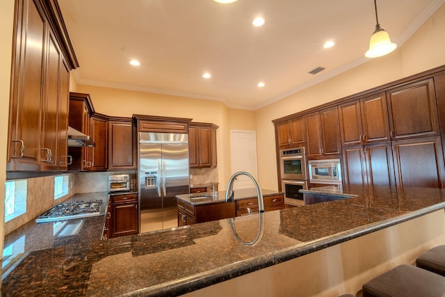 8979 Three Rail Dr, Boynton Beach, FL 33472 - kitchen with built in appliances, backsplash, recessed lighting, dark stone counters, and crown molding