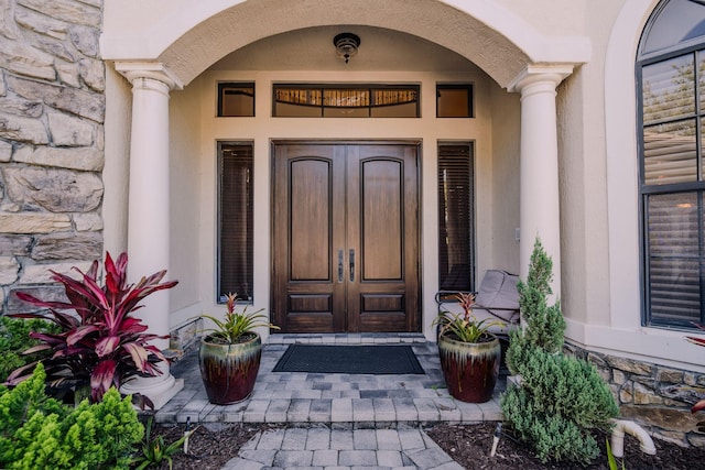 8979 Three Rail Dr, Boynton Beach, FL 33472 - doorway to property featuring stone siding, stucco siding, and french doors