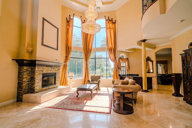 8979 Three Rail Dr, Boynton Beach, FL 33472 - living room featuring crown molding, a high ceiling, arched walkways, a stone fireplace, and marble tiled flooring