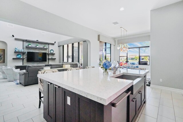 9196 Grand Prix Ln, Boynton Beach, FL 33472 - kitchen with a chandelier, a kitchen island with sink, hanging light fixtures, light tile patterned floors, and a sink