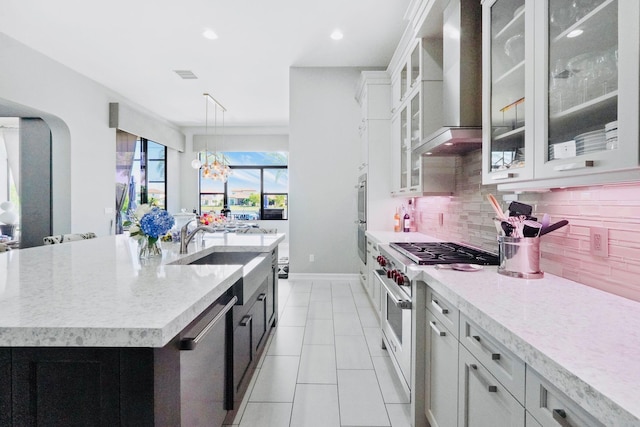 9196 Grand Prix Ln, Boynton Beach, FL 33472 - kitchen featuring wall chimney range hood, a sink, tasteful backsplash, stainless steel appliances, and an island with sink