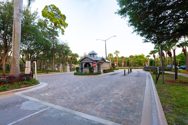 1325 Strawberry Ln, West Palm Beach, FL 33415 - view of road with traffic signs, street lights, and curbs