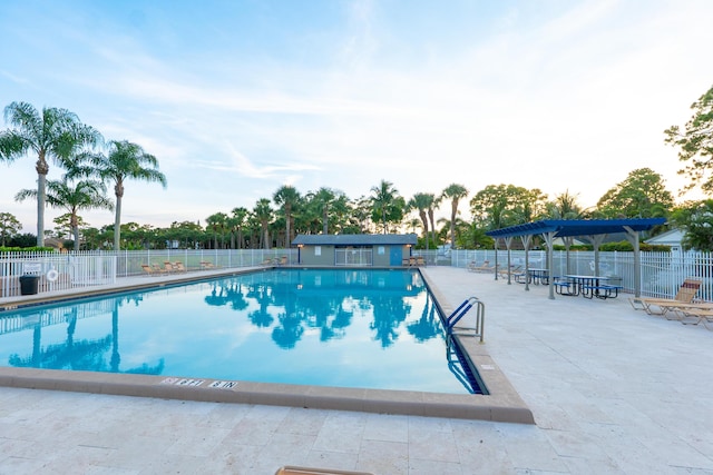 1325 Strawberry Ln, West Palm Beach, FL 33415 - community pool featuring a patio and a pergola