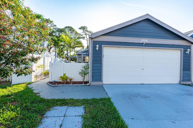 1325 Strawberry Ln, West Palm Beach, FL 33415 - garage with concrete driveway
