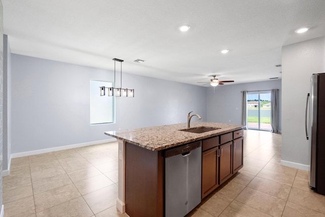 852 Gairloch Ln, Fort Pierce, FL 34947 - kitchen featuring stainless steel appliances, a sink, light stone counters, ceiling fan, and hanging light fixtures
