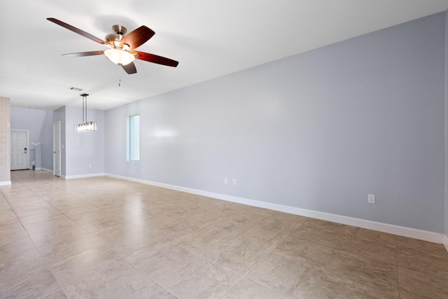 852 Gairloch Ln, Fort Pierce, FL 34947 - spare room featuring ceiling fan, baseboards, a chandelier, and light tile patterned floors