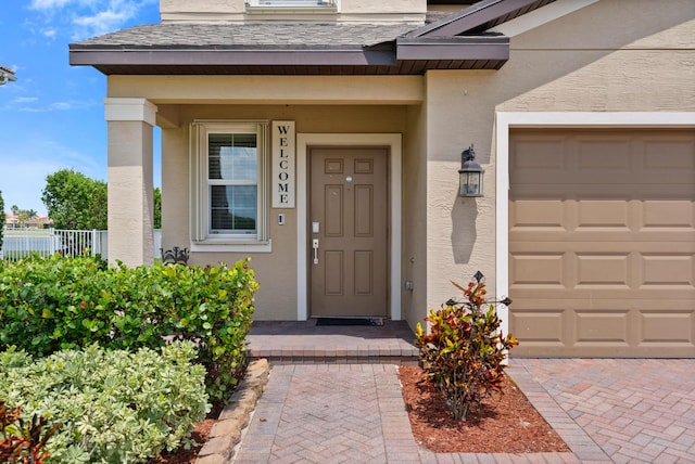 852 Gairloch Ln, Fort Pierce, FL 34947 - view of exterior entry featuring stucco siding and an attached garage