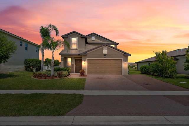 852 Gairloch Ln, Fort Pierce, FL 34947 - traditional home with driveway, a garage, stucco siding, and a front lawn