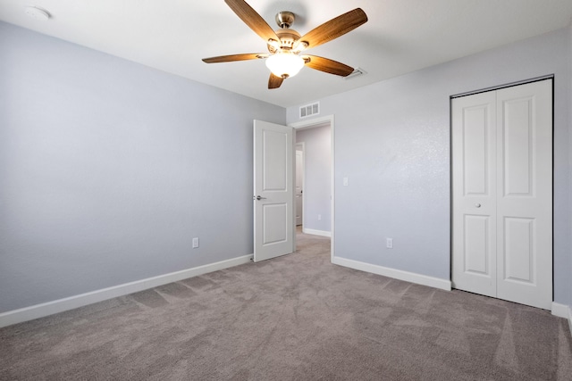 852 Gairloch Ln, Fort Pierce, FL 34947 - unfurnished bedroom featuring carpet floors, a closet, baseboards, and a ceiling fan