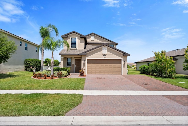852 Gairloch Ln, Fort Pierce, FL 34947 - view of front of property with stucco siding, decorative driveway, a garage, and a front yard