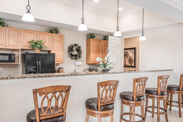 852 Gairloch Ln, Fort Pierce, FL 34947 - kitchen with black appliances, light brown cabinets, a kitchen breakfast bar, crown molding, and recessed lighting