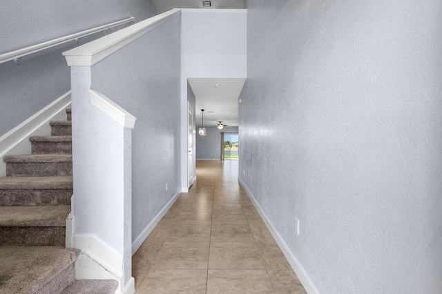 852 Gairloch Ln, Fort Pierce, FL 34947 - hall featuring baseboards, stairway, and a textured wall