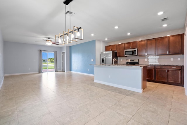 852 Gairloch Ln, Fort Pierce, FL 34947 - kitchen featuring appliances with stainless steel finishes, a sink, baseboards, hanging light fixtures, and recessed lighting