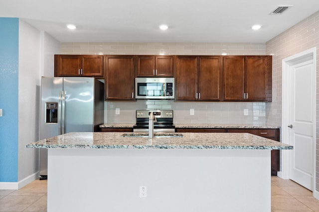 852 Gairloch Ln, Fort Pierce, FL 34947 - kitchen featuring stainless steel appliances, light tile patterned floors, a sink, light stone counters, and recessed lighting