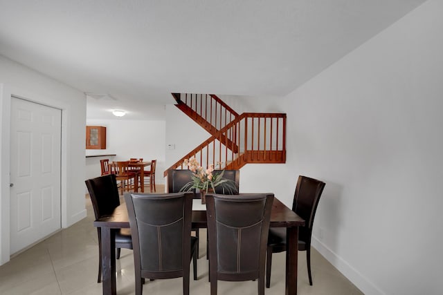 2938 SW 12th St, Deerfield Beach, FL 33442 - dining space featuring stairs, baseboards, and light tile patterned flooring