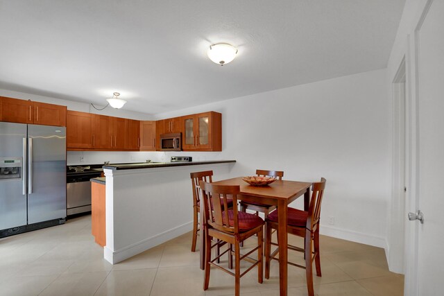 2938 SW 12th St, Deerfield Beach, FL 33442 - dining space with baseboards and light tile patterned floors