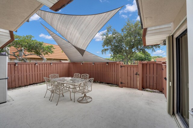 2938 SW 12th St, Deerfield Beach, FL 33442 - view of patio / terrace with a gate and outdoor dining space