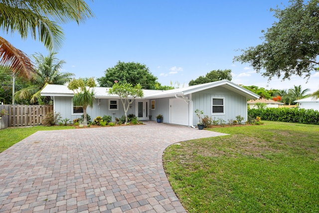 454 Tequesta Dr, Tequesta, FL 33469 - single story home with french doors, driveway, and board and batten siding