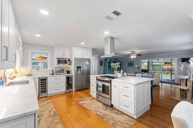 454 Tequesta Dr, Tequesta, FL 33469 - kitchen featuring appliances with stainless steel finishes, beverage cooler, a sink, open floor plan, and recessed lighting