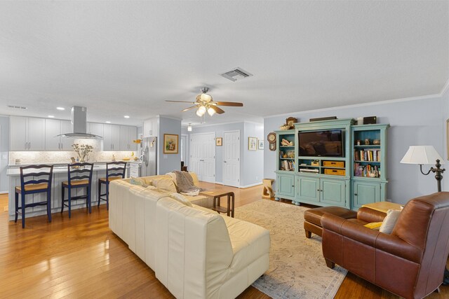 454 Tequesta Dr, Tequesta, FL 33469 - living room with ceiling fan, light wood-style flooring, ornamental molding, and recessed lighting