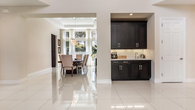 8520 Lewis River Rd, Delray Beach, FL 33446 - indoor wet bar with a raised ceiling, light tile patterned flooring, baseboards, and recessed lighting