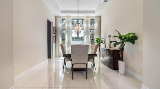 8520 Lewis River Rd, Delray Beach, FL 33446 - dining area with baseboards, a raised ceiling, and light tile patterned floors