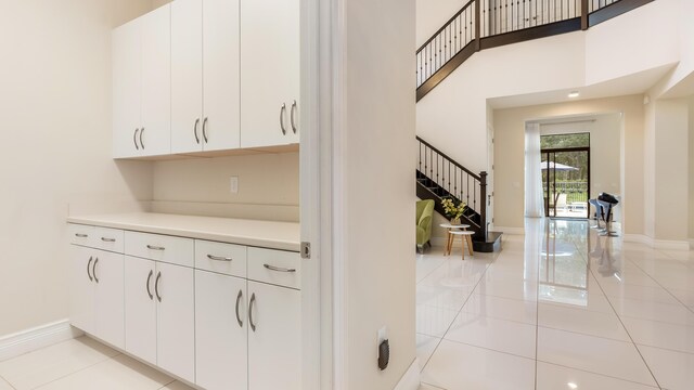 8520 Lewis River Rd, Delray Beach, FL 33446 - bar with stairs, light tile patterned floors, and baseboards