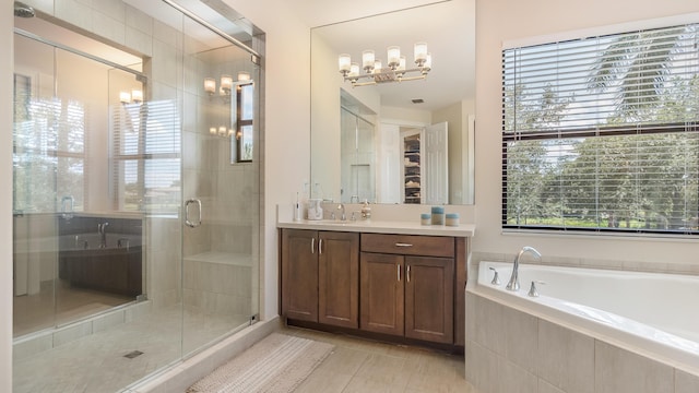8520 Lewis River Rd, Delray Beach, FL 33446 - full bathroom with a chandelier, a stall shower, vanity, tile patterned floors, and a garden tub