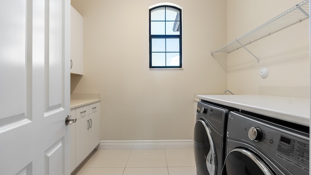 8520 Lewis River Rd, Delray Beach, FL 33446 - washroom featuring washer and clothes dryer, baseboards, cabinet space, and light tile patterned floors