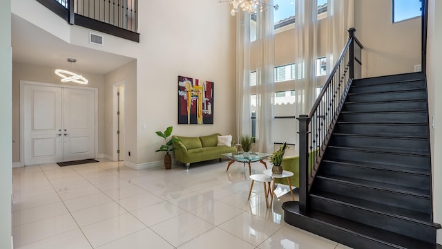 8520 Lewis River Rd, Delray Beach, FL 33446 - entrance foyer featuring a chandelier, a towering ceiling, plenty of natural light, stairway, and baseboards