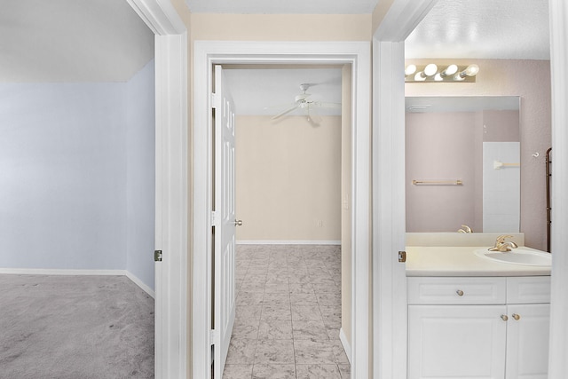 174 SE Kitching Cir Unit 174, Stuart, FL 34994 - bathroom featuring vanity, baseboards, and a ceiling fan
