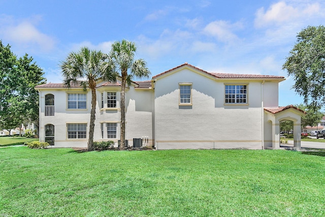 174 SE Kitching Cir Unit 174, Stuart, FL 34994 - view of front of property featuring a tile roof, a front lawn, and stucco siding