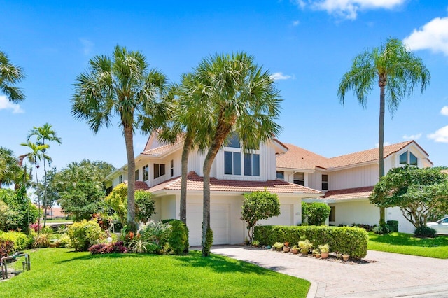 5846 NW 24th Ave Unit 202, Boca Raton, FL 33496 - mediterranean / spanish-style house featuring a tile roof, driveway, a front yard, and an attached garage