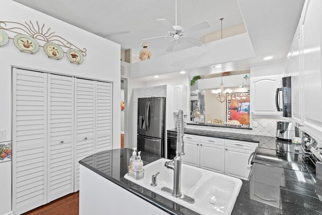 5846 NW 24th Ave Unit 202, Boca Raton, FL 33496 - kitchen featuring fridge with ice dispenser, electric stove, a ceiling fan, white cabinetry, and a chandelier
