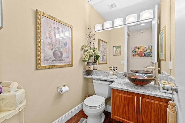 5846 NW 24th Ave Unit 202, Boca Raton, FL 33496 - bathroom featuring toilet, vanity, baseboards, and wood finished floors