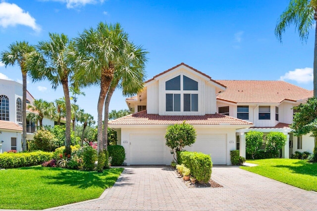 5846 NW 24th Ave Unit 202, Boca Raton, FL 33496 - mediterranean / spanish house featuring a tile roof, an attached garage, a front lawn, and stucco siding