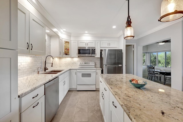 1800 SE Saint Lucie Blvd Unit 2-204, Stuart, FL 34996 - kitchen with appliances with stainless steel finishes, a sink, light stone counters, ornamental molding, and decorative backsplash
