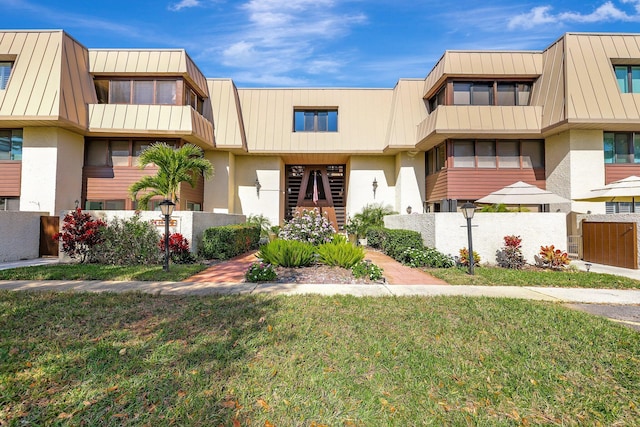 1800 SE Saint Lucie Blvd Unit 2-204, Stuart, FL 34996 - view of front of property with a standing seam roof, stucco siding, and metal roof