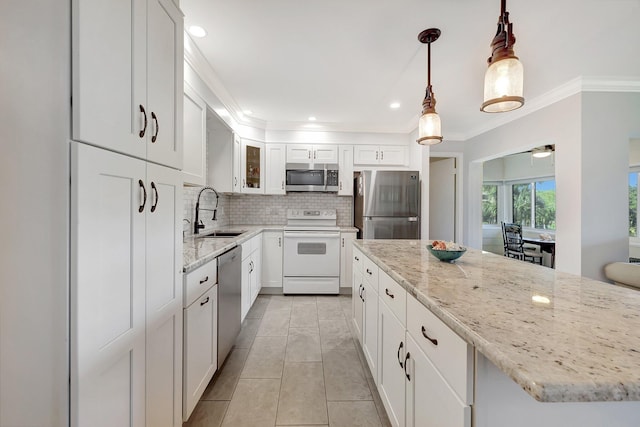 1800 SE Saint Lucie Blvd Unit 2-204, Stuart, FL 34996 - kitchen with appliances with stainless steel finishes, a sink, backsplash, crown molding, and light stone countertops