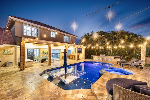 view of swimming pool with a patio area and a pool with connected hot tub