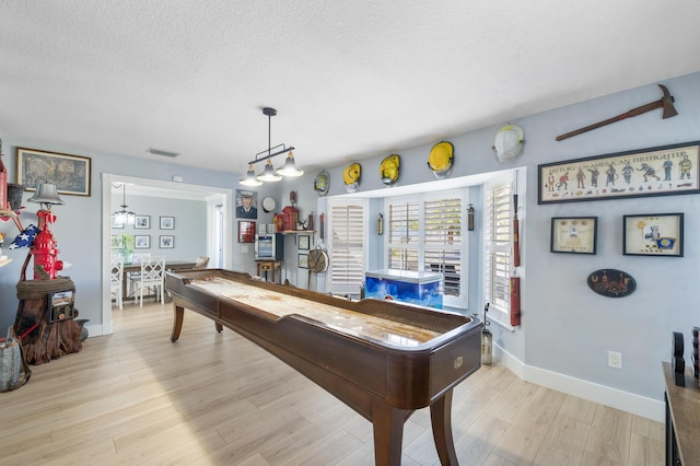 playroom with a textured ceiling, wood finished floors, baseboards, and billiards