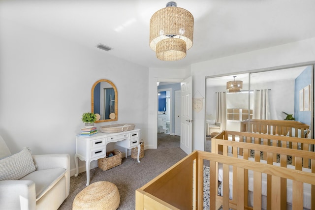 bedroom featuring carpet floors, a chandelier, baseboards, and a closet