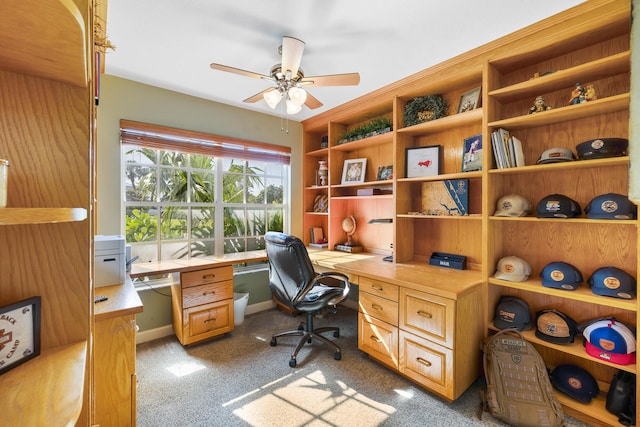 office featuring ceiling fan, light carpet, and baseboards
