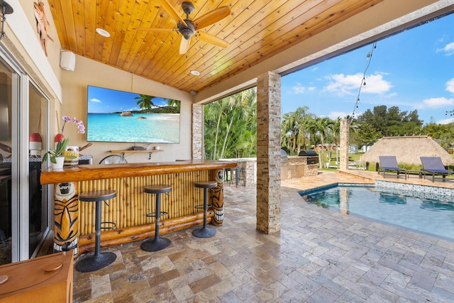 view of patio / terrace with area for grilling, an outdoor pool, and ceiling fan