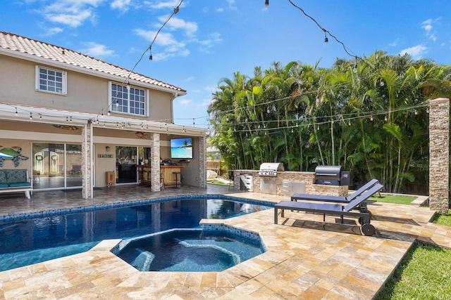 view of swimming pool with a patio area, a bar, and a pool with connected hot tub