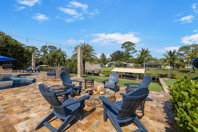 view of patio / terrace featuring an outdoor fire pit and an outdoor pool