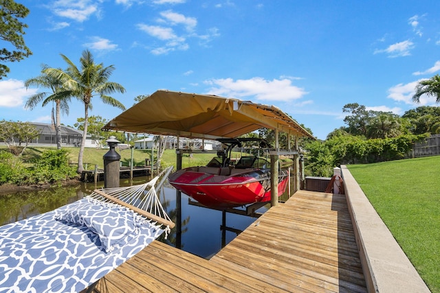dock area featuring boat lift, a water view, and a yard