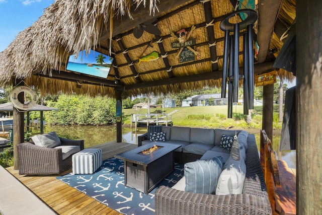 deck featuring a gazebo and an outdoor living space with a fire pit