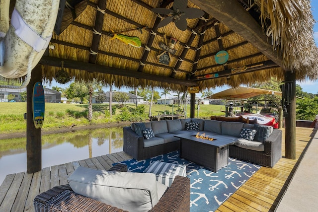 dock featuring a gazebo, an outdoor living space with a fire pit, and a water view