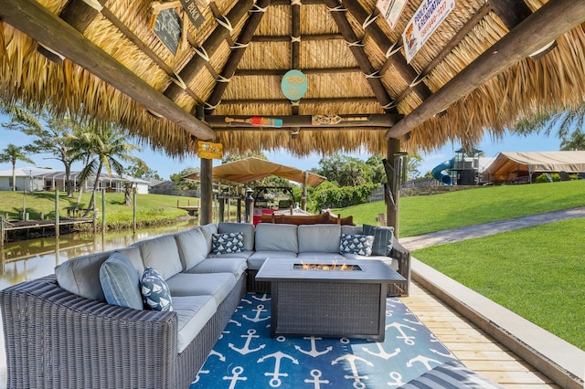 view of patio / terrace with a gazebo, an outdoor living space with a fire pit, and a water view